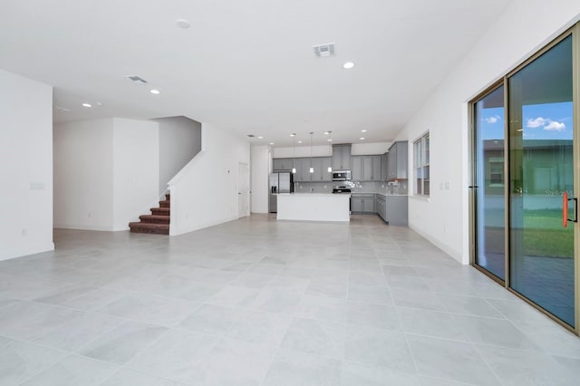 unfurnished living room with light tile patterned floors