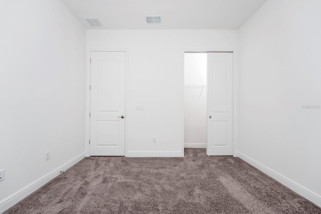 unfurnished bedroom with a closet and carpet