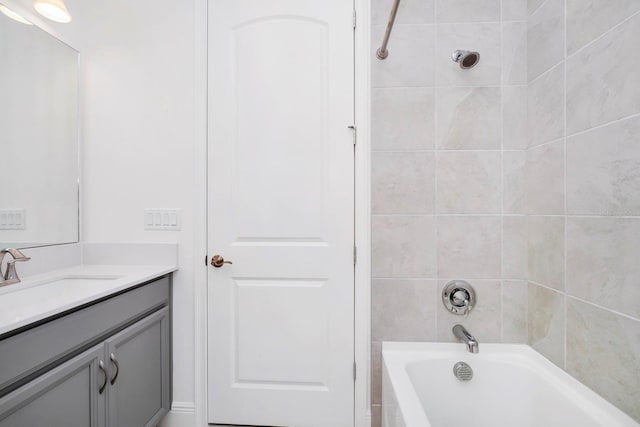 bathroom featuring vanity and tiled shower / bath combo