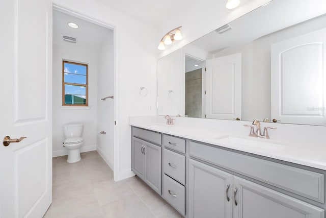 bathroom with tile patterned flooring, vanity, and toilet