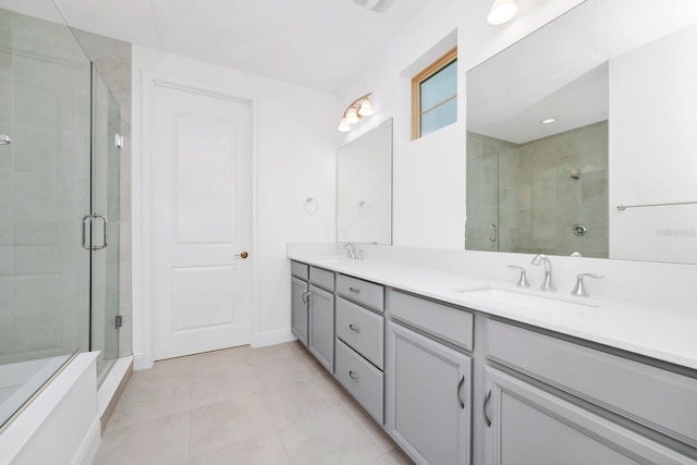 bathroom with tile patterned floors, vanity, and a shower with door