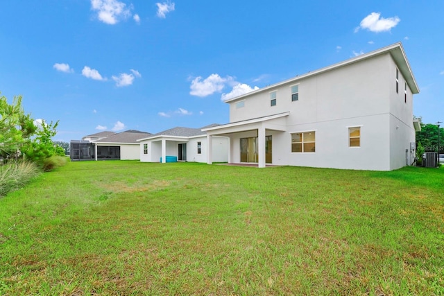 rear view of property featuring a lawn and cooling unit