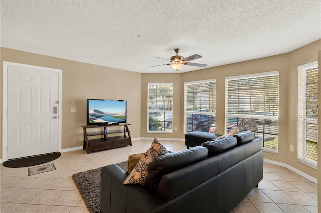 tiled living room with ceiling fan and a textured ceiling