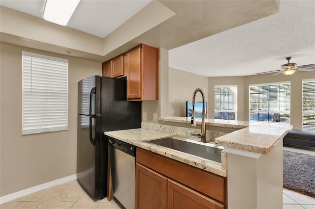 kitchen featuring kitchen peninsula, stainless steel dishwasher, a textured ceiling, ceiling fan, and sink