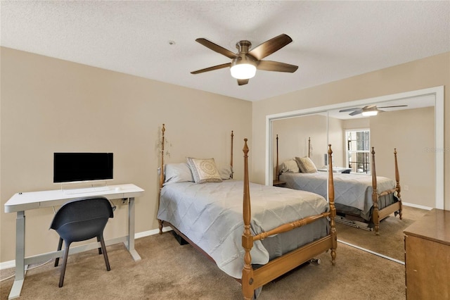 bedroom with a textured ceiling, carpet floors, a closet, and ceiling fan