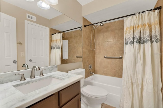 full bathroom with shower / bath combination with curtain, vanity, and toilet