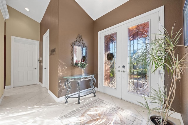 tiled foyer with french doors and vaulted ceiling