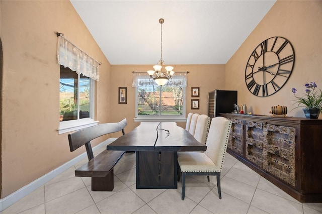 tiled dining room with a notable chandelier, a healthy amount of sunlight, and lofted ceiling