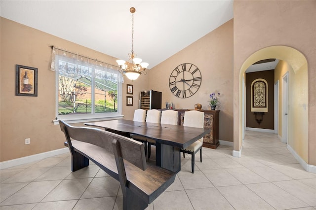 tiled dining area with a chandelier and lofted ceiling