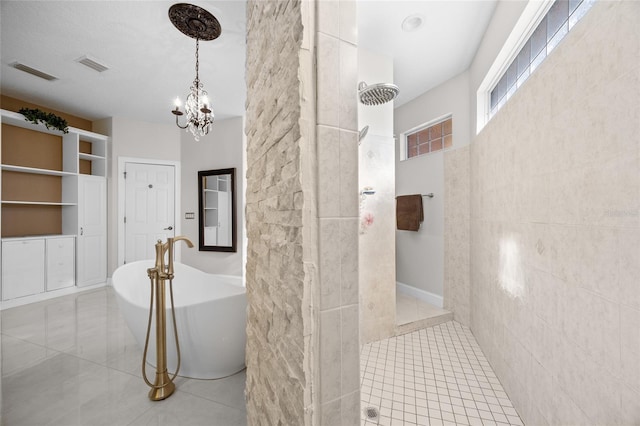 bathroom featuring tile patterned floors, tile walls, independent shower and bath, and an inviting chandelier