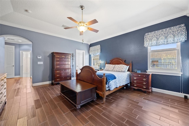 bedroom with a textured ceiling, dark hardwood / wood-style floors, ceiling fan, and crown molding