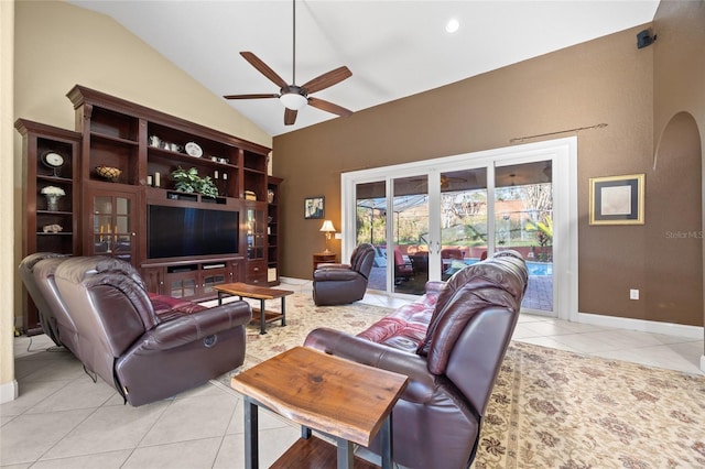 tiled living room with ceiling fan and lofted ceiling