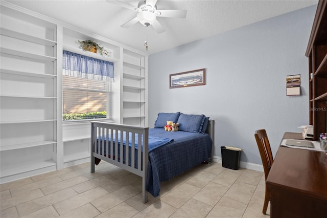 bedroom featuring ceiling fan, light tile patterned flooring, and a textured ceiling