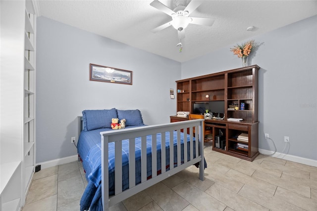 bedroom with a textured ceiling, ceiling fan, and light tile patterned flooring