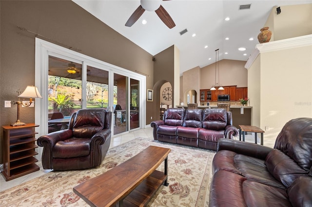 tiled living room with high vaulted ceiling and ceiling fan