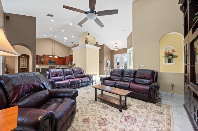 living room featuring ceiling fan, french doors, high vaulted ceiling, and light tile patterned floors