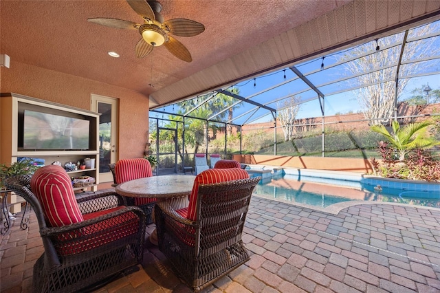 view of patio / terrace with glass enclosure and ceiling fan