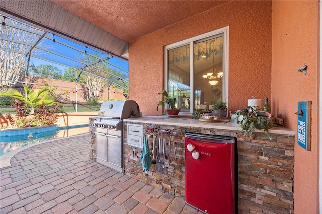 view of patio / terrace with an outdoor kitchen, a grill, and glass enclosure