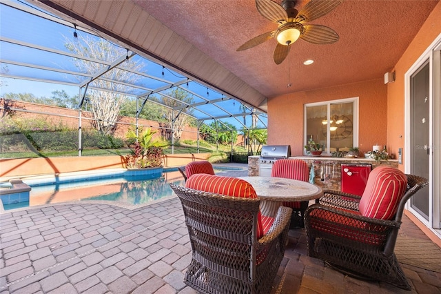 view of patio featuring ceiling fan, a lanai, and grilling area