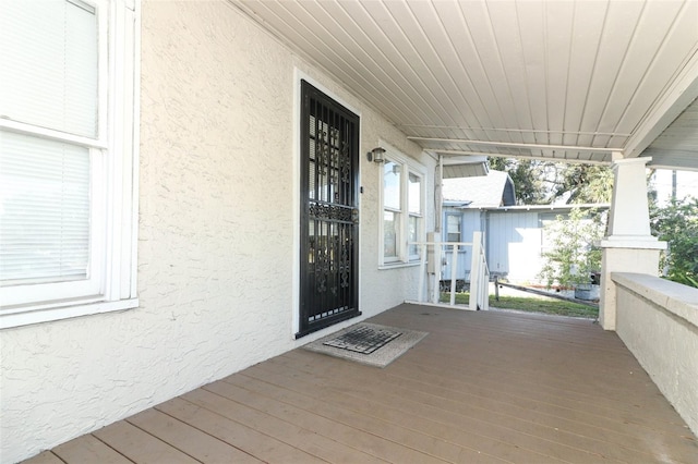 wooden deck featuring covered porch