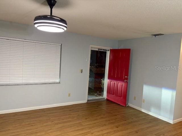 spare room with dark hardwood / wood-style floors