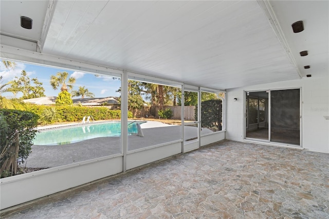 unfurnished sunroom featuring vaulted ceiling