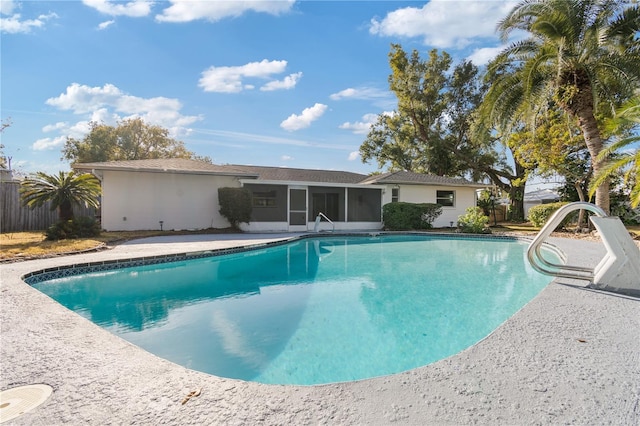 view of swimming pool featuring a sunroom