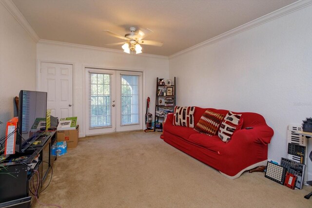 carpeted living room with crown molding and ceiling fan