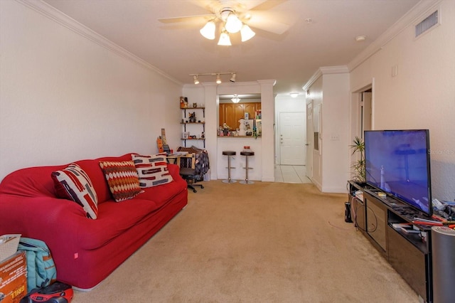 living room featuring light carpet, ceiling fan, and ornamental molding