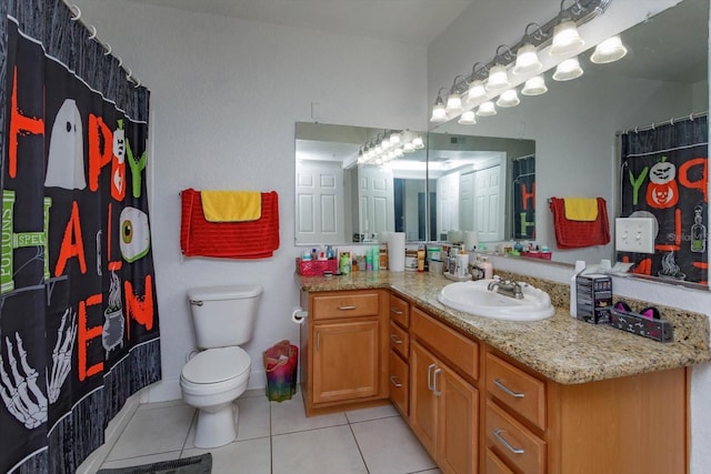 bathroom with toilet, vanity, tile patterned floors, and a shower with shower curtain