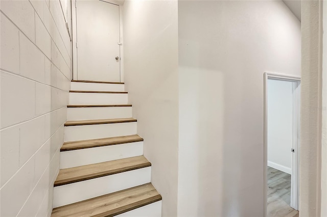 stairs featuring wood-type flooring