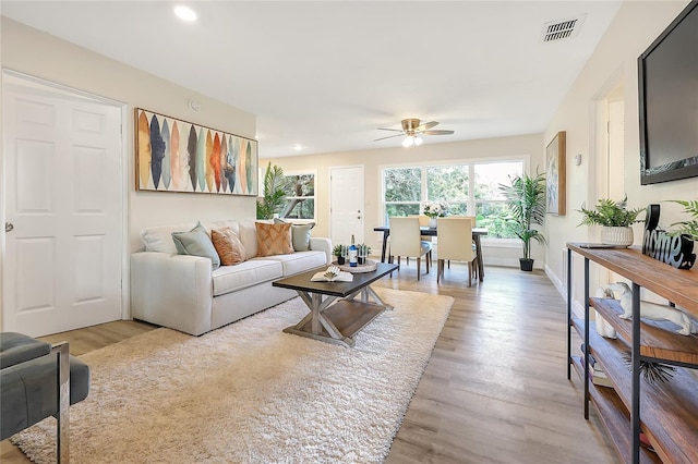 living room featuring ceiling fan and light wood-type flooring