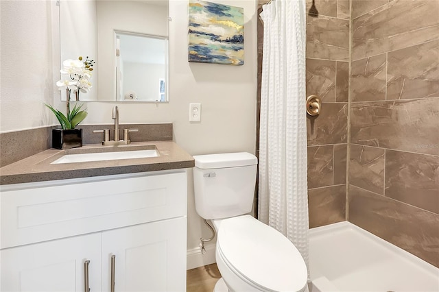 bathroom featuring vanity, toilet, and walk in shower