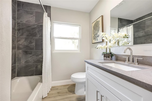 full bathroom with wood-type flooring, vanity, toilet, and shower / bath combo with shower curtain