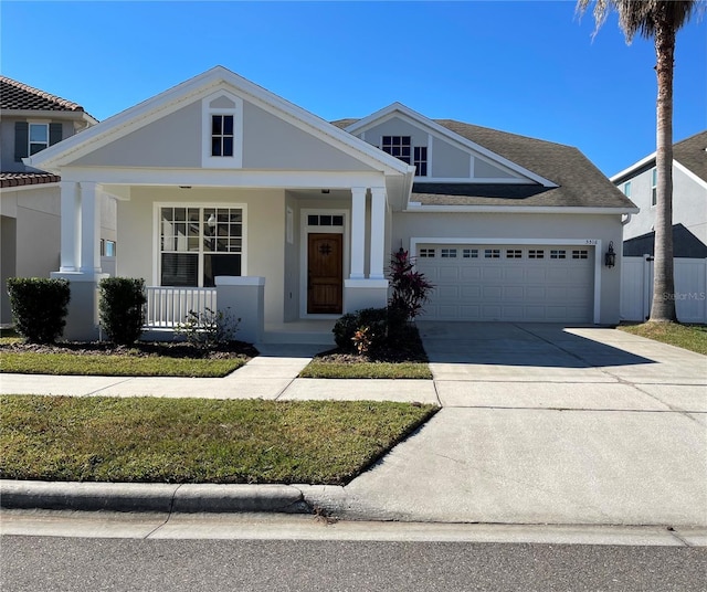 view of front of house featuring a porch and a garage