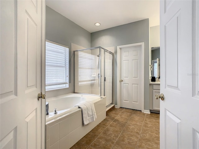 bathroom featuring shower with separate bathtub and tile patterned flooring