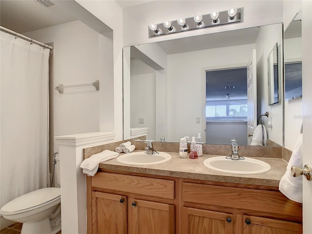 bathroom with toilet and vanity