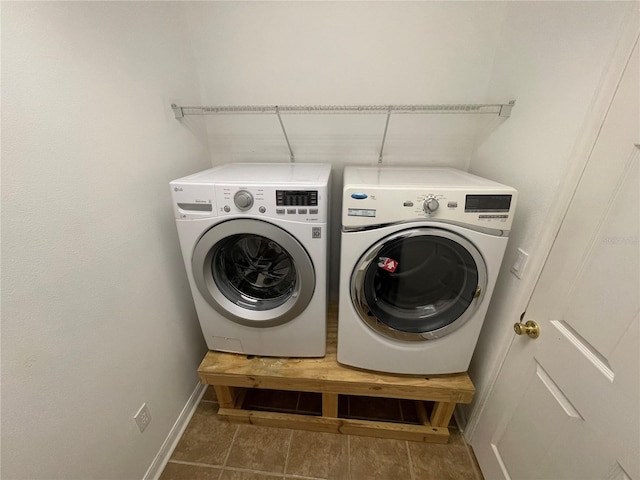 clothes washing area with washing machine and dryer