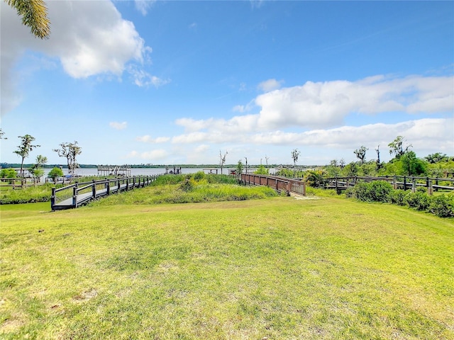 view of yard with a rural view and a water view