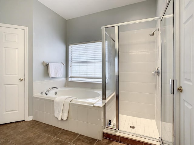 bathroom with separate shower and tub and tile patterned flooring