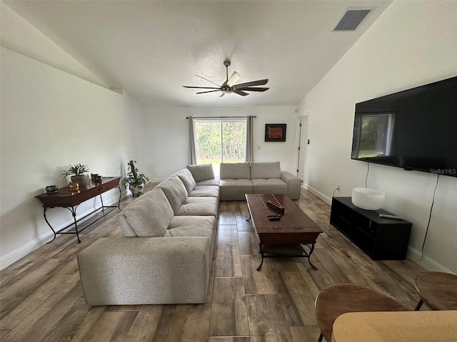 living room featuring hardwood / wood-style flooring, ceiling fan, and lofted ceiling