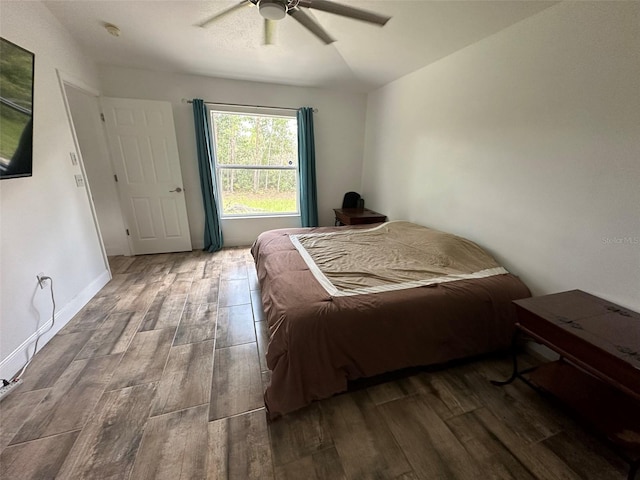 bedroom with ceiling fan and hardwood / wood-style flooring