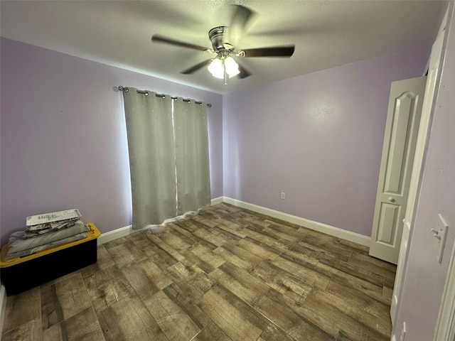 spare room featuring hardwood / wood-style flooring and ceiling fan