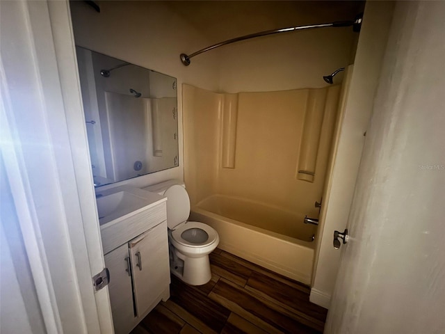 full bathroom featuring bathtub / shower combination, wood-type flooring, vanity, and toilet