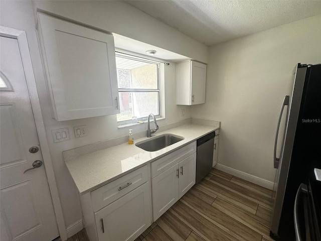 kitchen featuring white cabinets, light hardwood / wood-style floors, sink, and stainless steel appliances