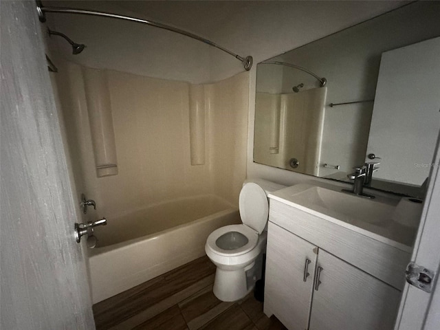 full bathroom with hardwood / wood-style floors, vanity, toilet, and shower / washtub combination