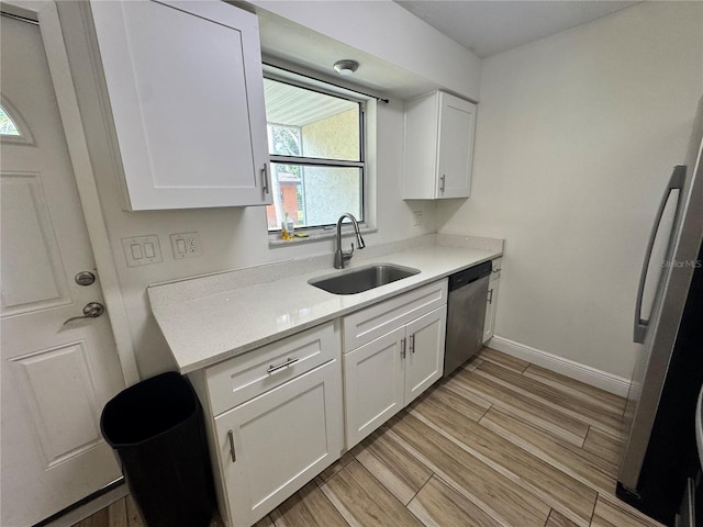 1234 Sago Palm Blvd Unit 1234, Kissimmee, FL 34741 - kitchen with stainless steel appliances, a sink, light countertops, and white cabinets