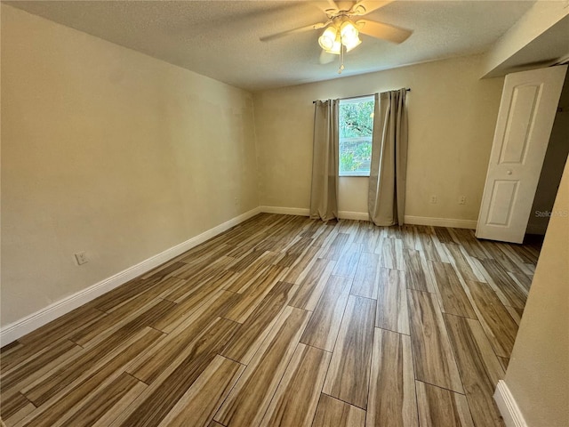 1234 Sago Palm Blvd Unit 1234, Kissimmee, FL 34741 - spare room featuring wood finished floors, baseboards, ceiling fan, and a textured ceiling