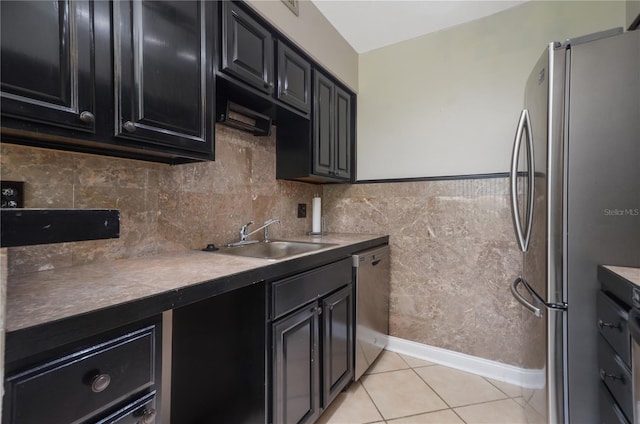 kitchen with appliances with stainless steel finishes, sink, and light tile patterned floors