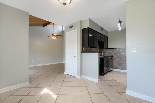 kitchen featuring lofted ceiling, ceiling fan, dishwasher, light tile patterned floors, and decorative backsplash